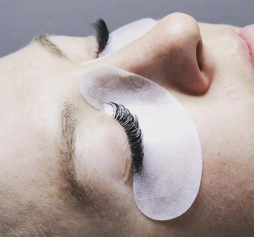 Lash lift treatment in progress — crescent lash pad fitted, natural curl lifting above