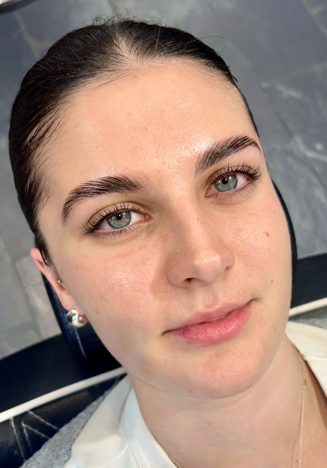 Three-quarter portrait showing laminated brows and lash extensions